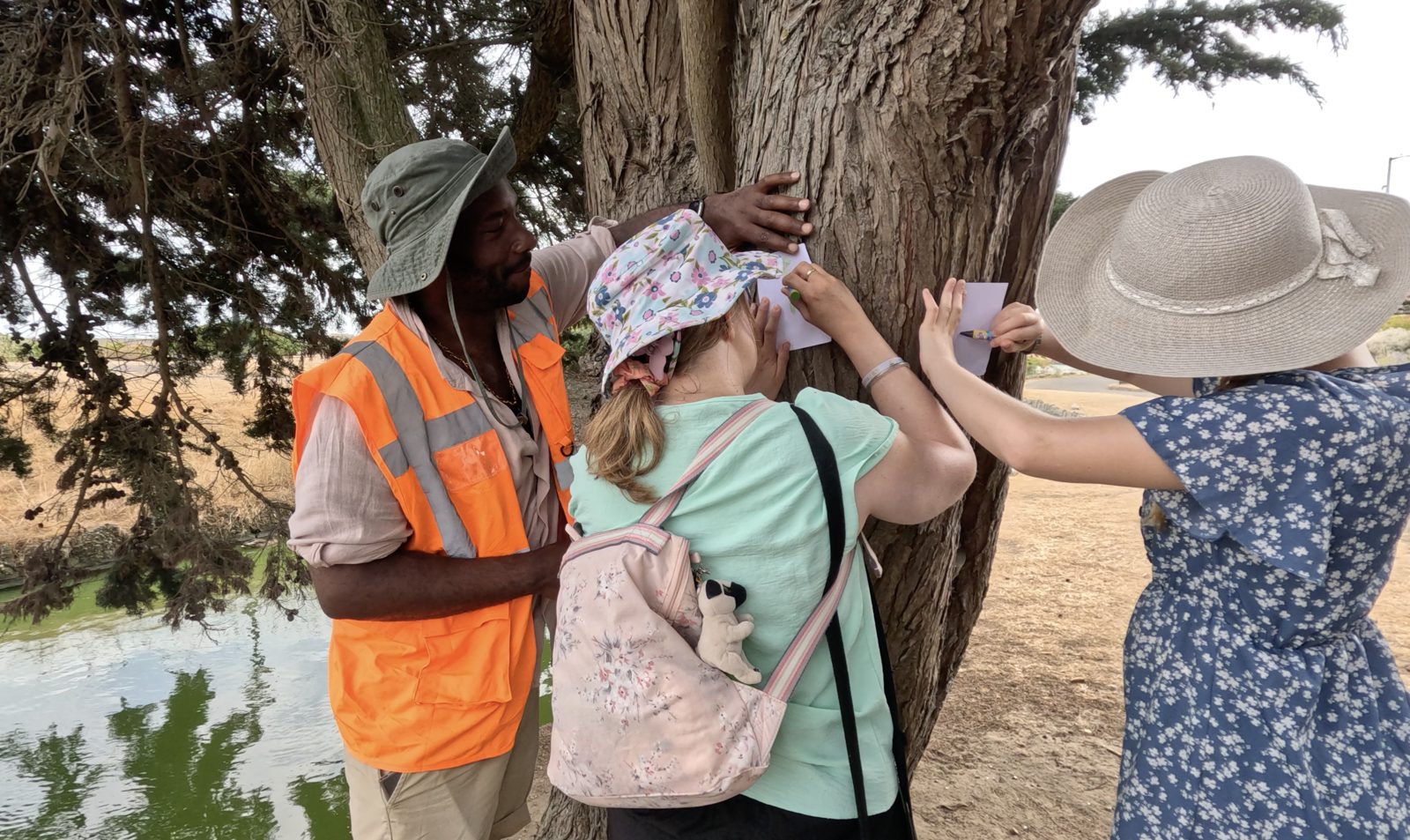 Participants exploring the texture of a tree trunk