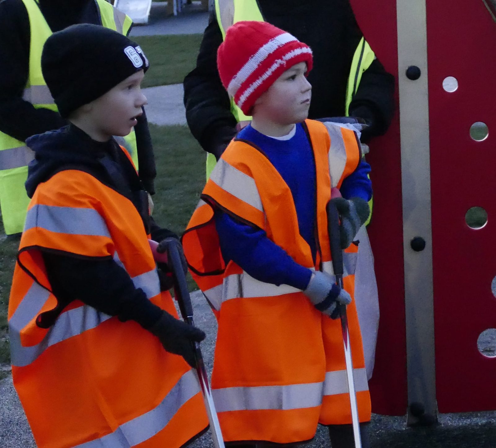 Children in hi-vis vests litter picking